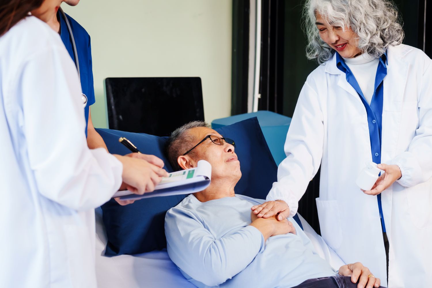 elderly man lying in hospital bed